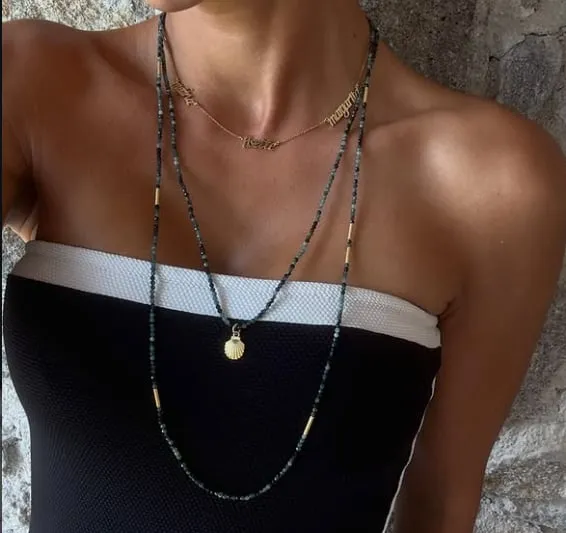 Long beaded necklaces with a gold seashell pendant